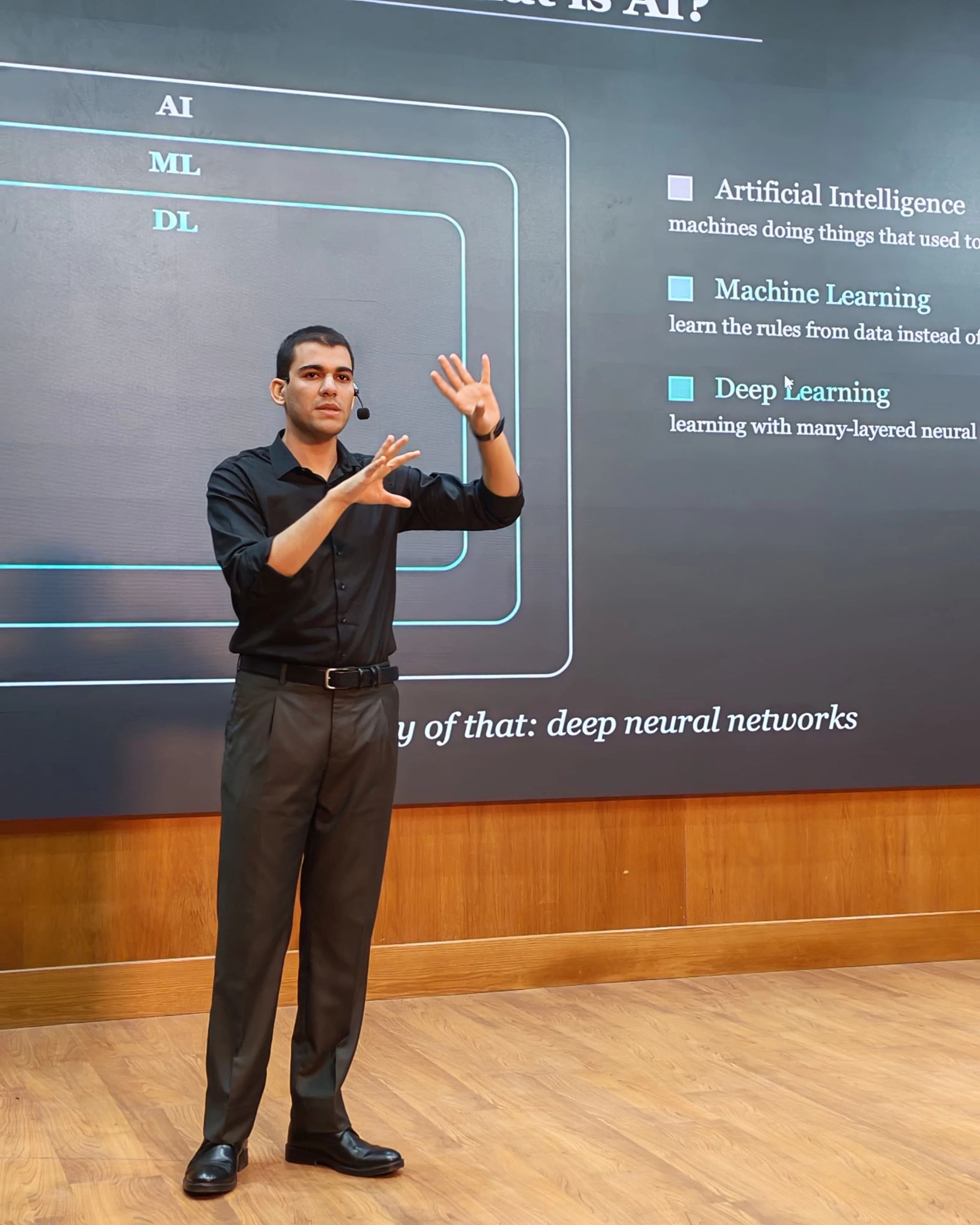 LLM Engineering Bootcamp: From Foundations to Deployment: Moaz on stage explaining AI vs ML vs DL vs GenAI vs LLMs