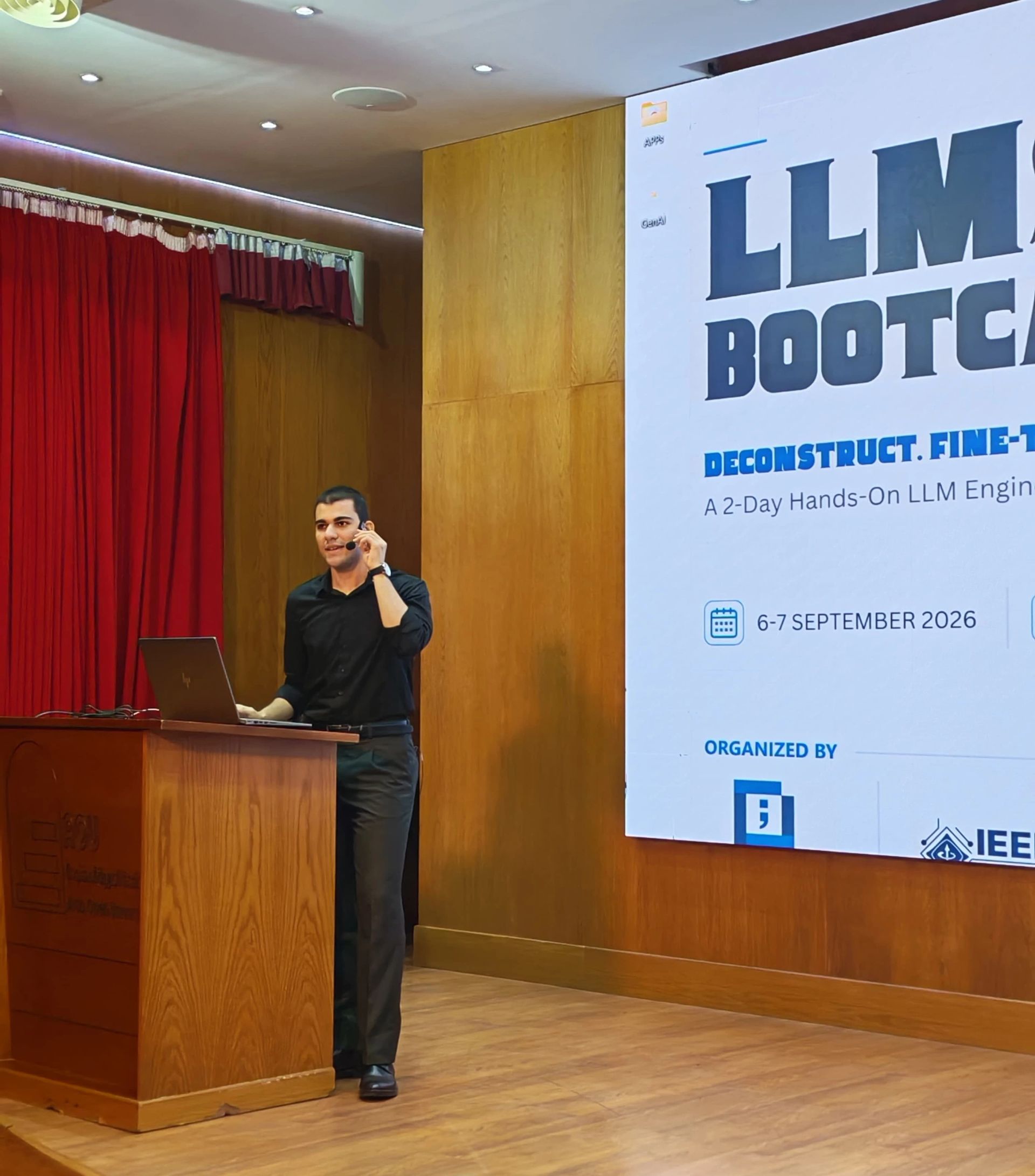 LLM Engineering Bootcamp: From Foundations to Deployment: Moaz on stage holding mic with one hand